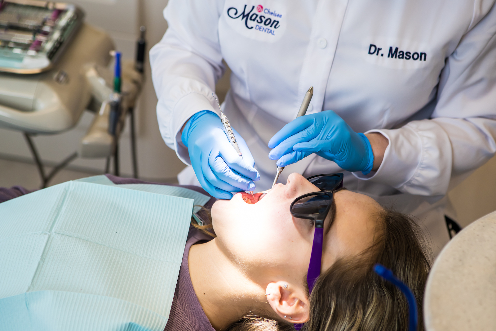 Dr. Mason checks on a child's teeth during a pediatric dentistry exam.