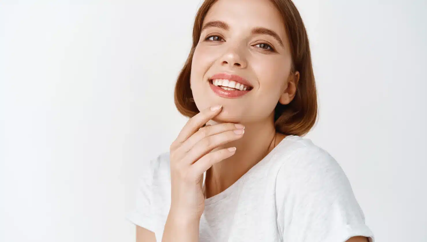 Smiling woman with healthy teeth and clear skin, promoting dental health and orthodontics.