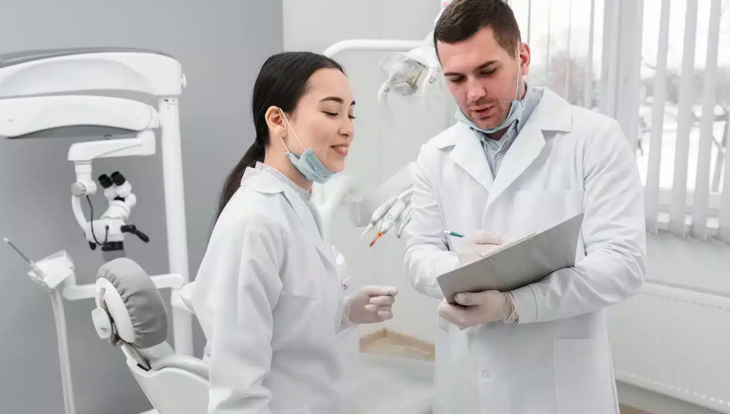 Dental professionals discussing patient care in a modern dental office setting, emphasizing orthodontics and children's dentistry.