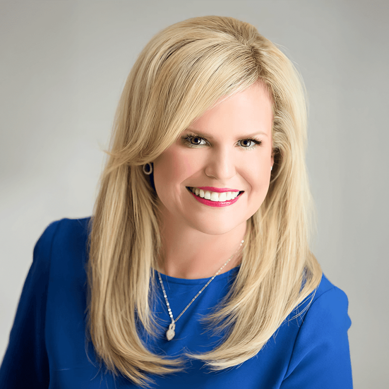 Dr. Chelsea Mason, smiling woman in blue attire, general and family dentist in Bay City, Michigan.