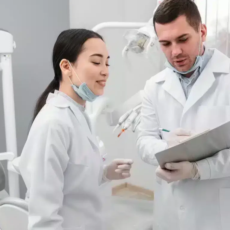 Dental professionals discussing dental implant procedures in a modern clinic setting.